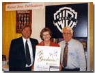 “Go Gershwin” with Warner Bros. Music in the background. L to R, Geoff Haydon, Carole Flatau (former Keyboard Editor, Warner Bros. Music) and Jim Lyke at an MTNA convention in the mid-1990s.