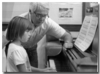 Jim Lyke working with a piano lab student at the University of Illinois